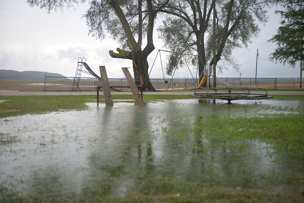 Rain water fills a playground at the Hartsburg Ball Park